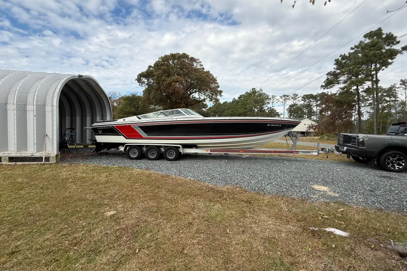 Slide: The Image of 1988 Formula 311 SR-1 boat on trailer outside storage shed. - 2