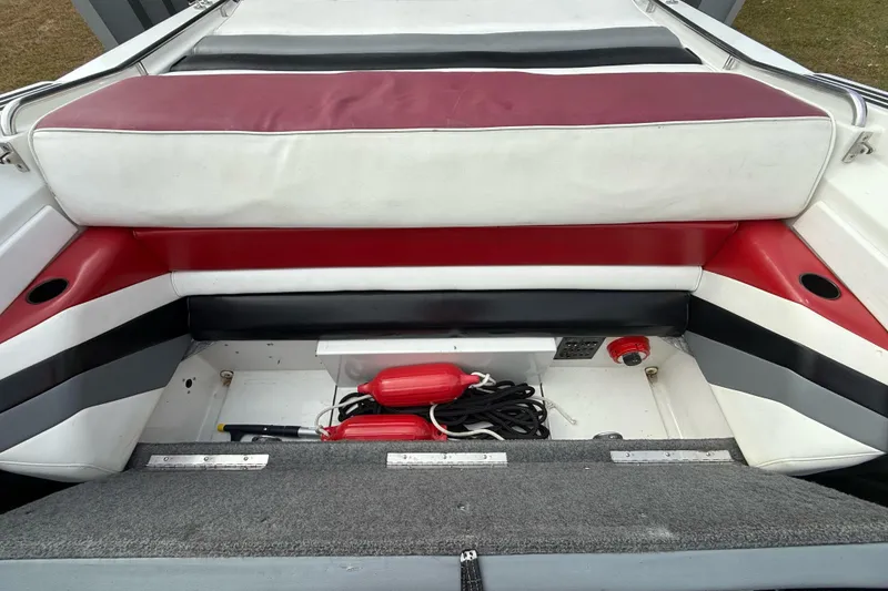 Slide: The Image of 1988 Thunderbird Formula 311 SR1 boat interior with red and white seating and storage area. - 20