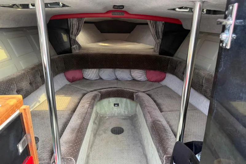 Slide: The Image of 1988 Thunderbird Formula 311 SR1 cabin interior with plush seating and pillows. - 22