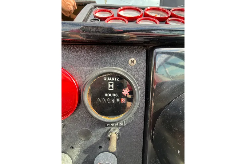 Slide: The Image of 1988 Thunderbird Formula 311 SR1 dashboard with quartz hour meter reading 60.2 hours. - 25