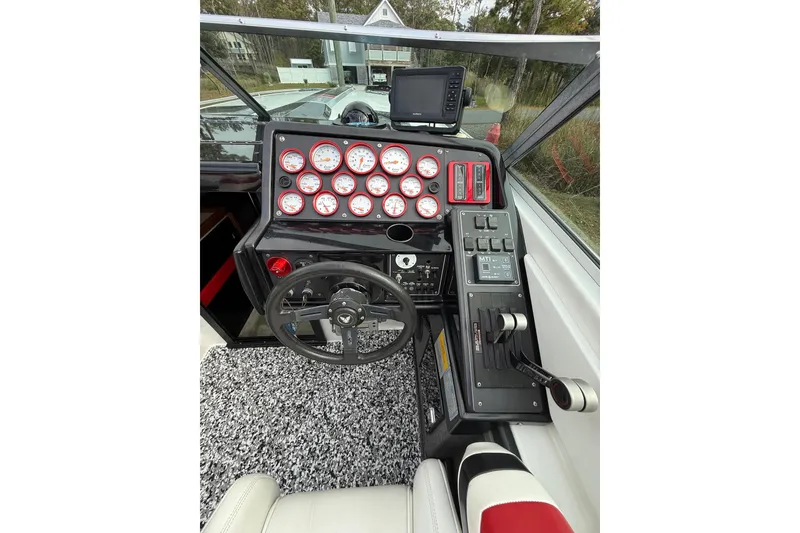 Slide: The Image of 1988 Thunderbird Formula 311 SR1 boat cockpit with gauges and steering wheel. - 26