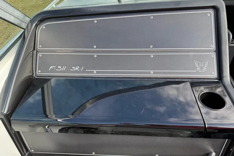 Slide: The Image of 1988 Thunderbird Formula 311 SR1 dashboard with sleek black design and emblem. - 30