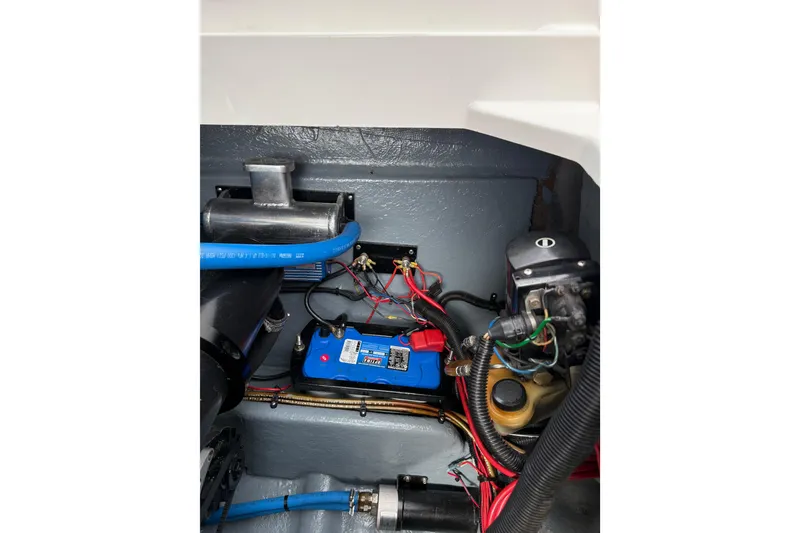 Slide: The Image of Engine compartment of 1988 Thunderbird Formula 311 SR1 with visible battery and wiring. - 34