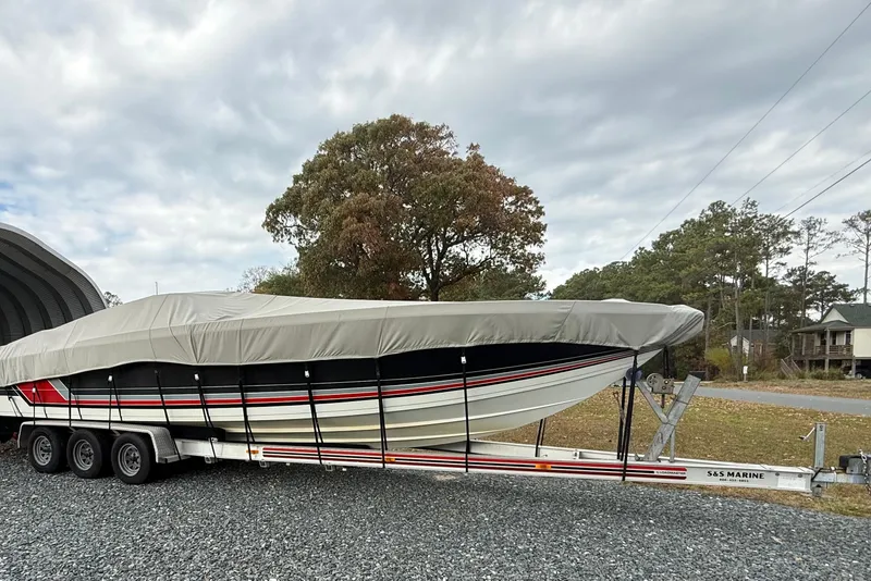 Slide: The Image of 1988 Thunderbird Formula 311 SR1 boat on trailer, covered, outdoors. - 5