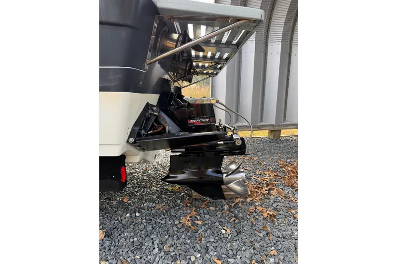 Slide: The Image of 1988 Thunderbird Formula 311 SR1 boat with Mercury outboard motor on gravel. - 7