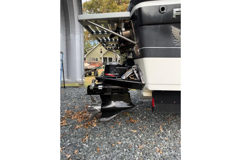 Slide: The Image of 1988 Thunderbird Formula 311 SR1 boat with Mercury outboard motor, parked on gravel. - 8