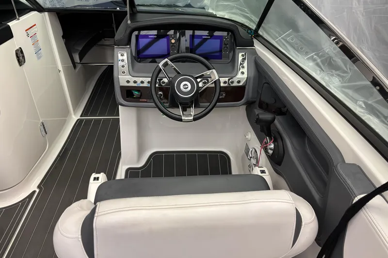 Slide: The Image of 2018 Chaparral 287 SSX boat cockpit with modern steering and navigation controls. - 11