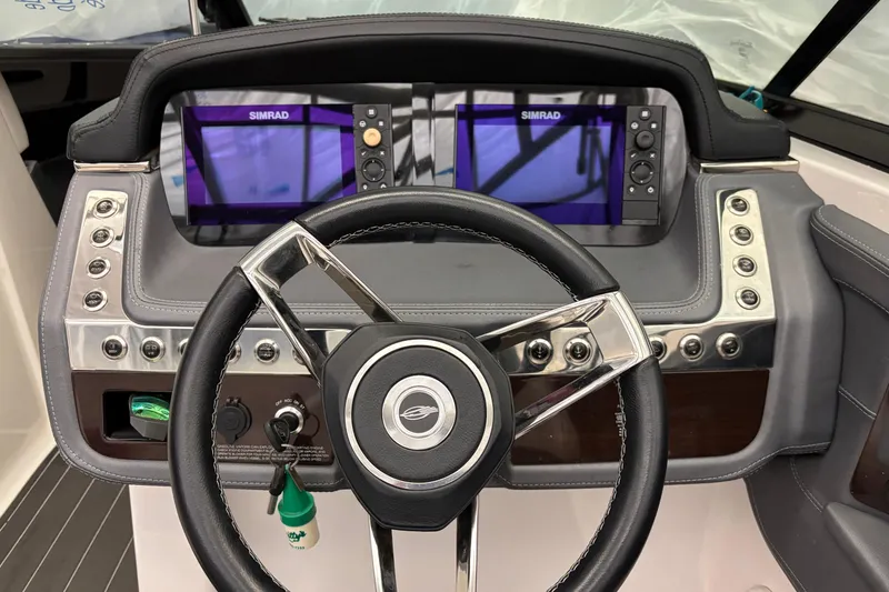 Slide: The Image of 2018 Chaparral 287 SSX dashboard with dual Simrad displays and steering wheel. - 12