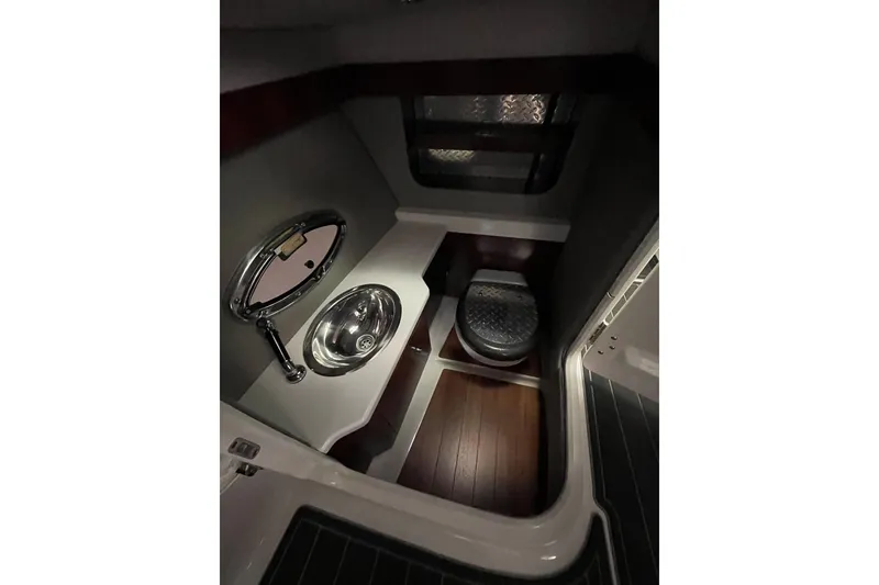 Slide: The Image of 2018 Chaparral 287 SSX boat interior with sink and toilet, featuring modern design. - 14