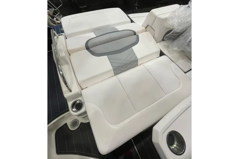 Slide: The Image of 2018 Chaparral 287 SSX boat interior with white cushioned seating. - 19