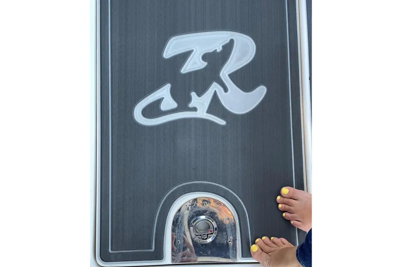 Slide: The Image of 2018 Chaparral 287 SSX boat deck with logo and yellow-painted toenails. - 5