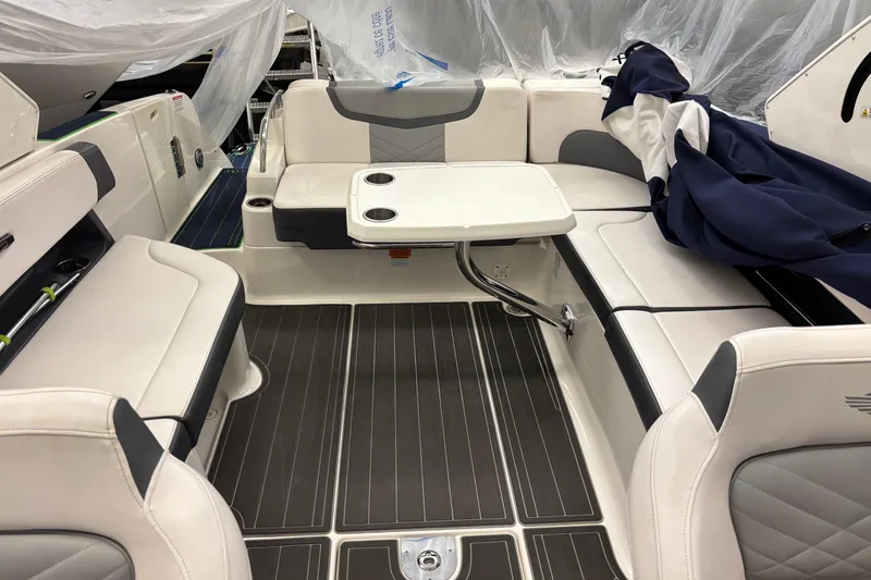 Slide: The Image of 2018 Chaparral 287 SSX boat interior with seating and table setup. - 8