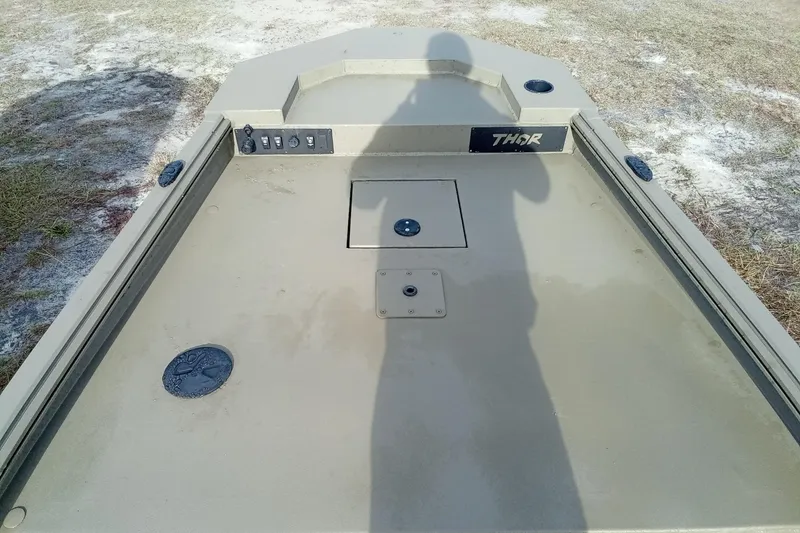 Slide: The Image of 2026 Thor 1754 Swamp Hammer boat deck with control panel and shadow. - 10