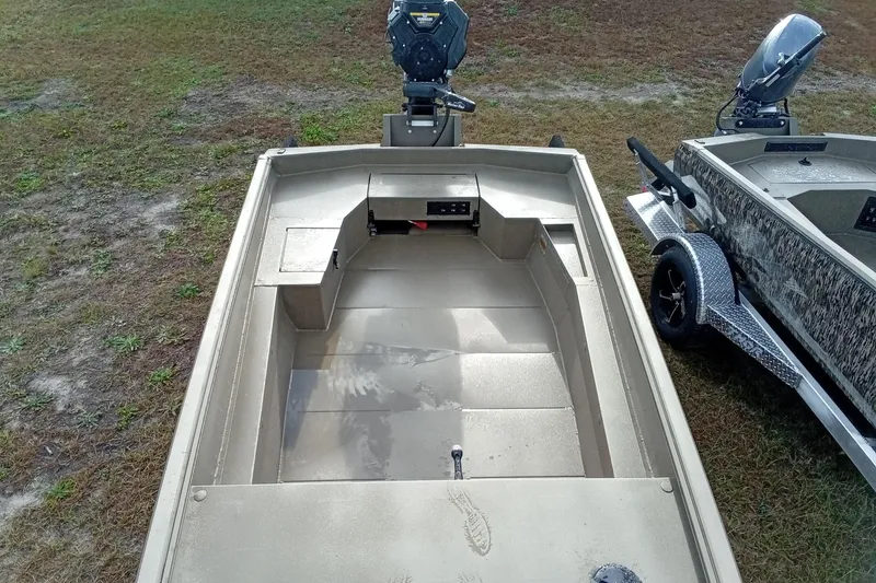 Slide: The Image of 2026 Thor 1754 Swamp Hammer boat on grass, featuring open deck and motor. - 12