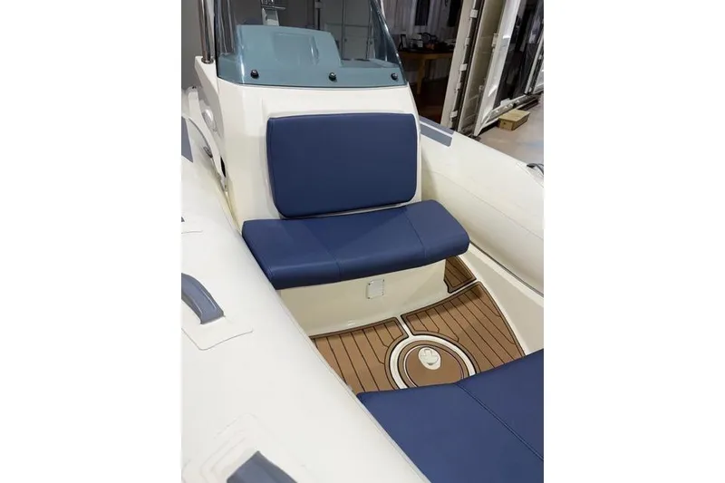 Slide: The Image of 2019 Brig Eagle 5 boat interior with blue seating and wooden deck. - 4