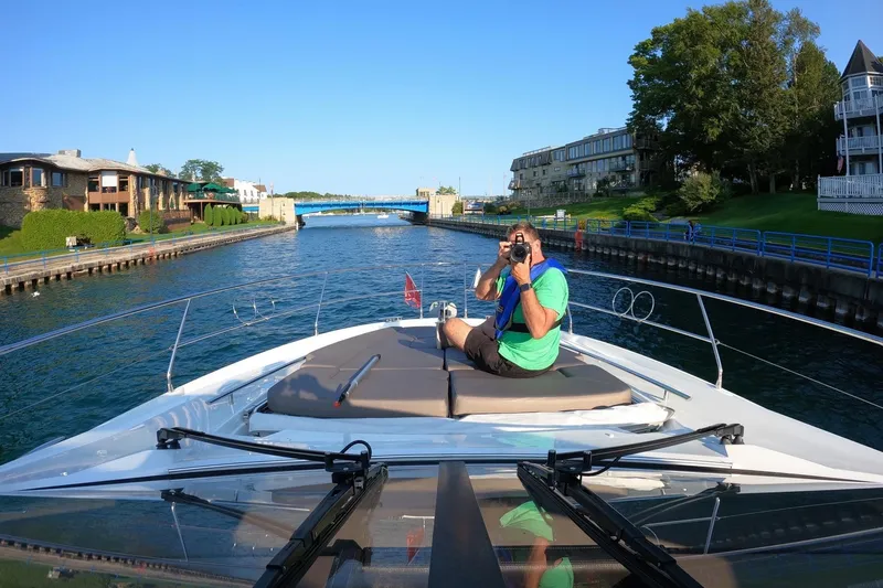 Slide: The Image of Man photographing from 2017 Prestige 500S yacht on a scenic canal. - 12