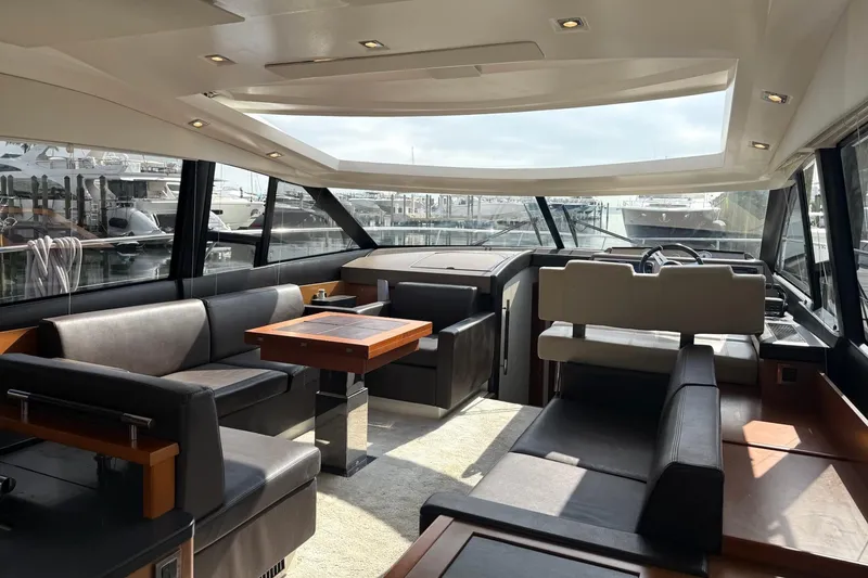 Slide: The Image of Luxurious interior of a 2017 Prestige 500S yacht with modern seating and panoramic windows. - 16