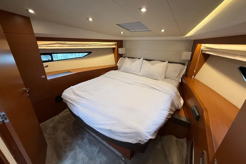 Slide: The Image of Luxurious bedroom interior of 2017 Prestige 500S yacht with cozy bedding and modern lighting. - 20