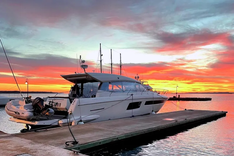 Slide: The Image of Luxury 2017 Prestige 500S yacht docked at sunset, vibrant sky reflecting on water. - 7