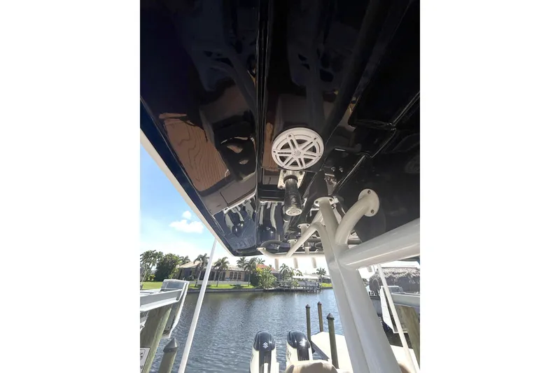 Slide: The Image of 2019 Cape Horn 27XS boat interior view with speaker, docked by waterfront homes. - 17