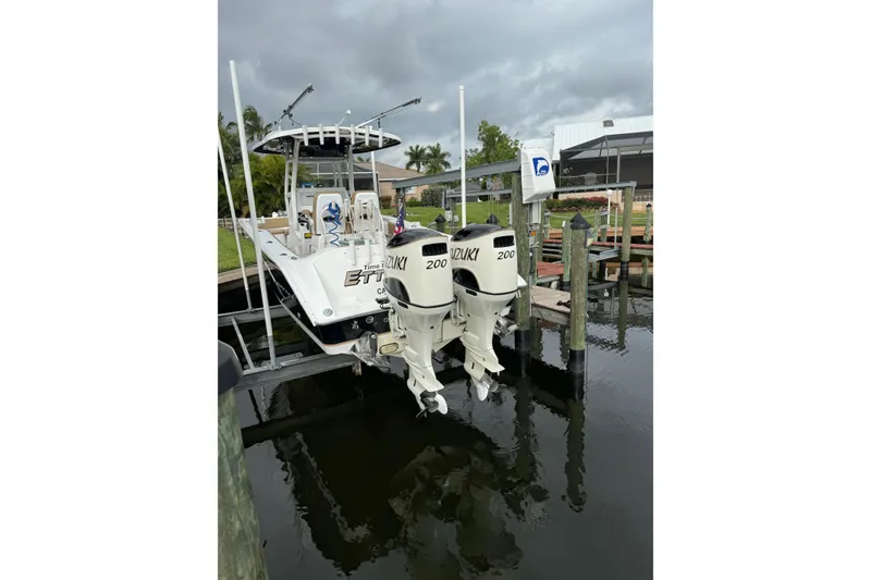 Slide: The Image of 2019 Cape Horn 27 XS boat with twin Suzuki 200 engines docked by the water. - 2