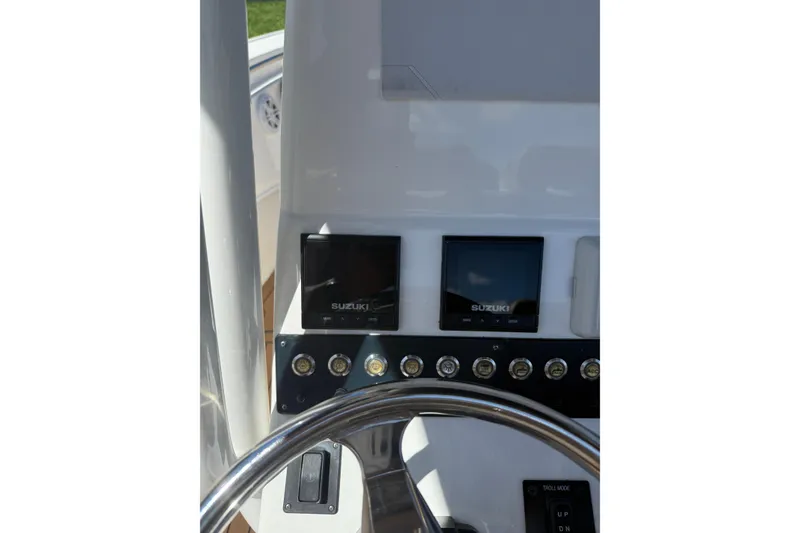 Slide: The Image of 2019 Cape Horn 27XS boat dashboard with Suzuki displays and controls. - 21