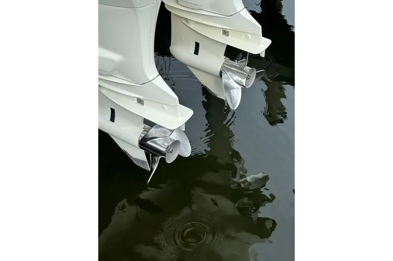 Slide: The Image of Twin outboard motors of a 2019 Cape Horn 27 XS reflecting on water. - 25