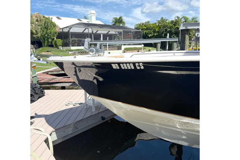 Slide: The Image of 2019 Cape Horn 27XS boat docked under a clear blue sky. - 5