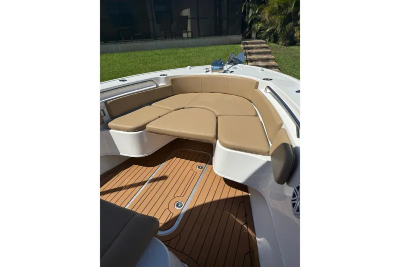 Slide: The Image of 2019 Cape Horn 27XS boat with tan cushioned seating and teak-style flooring. - 9