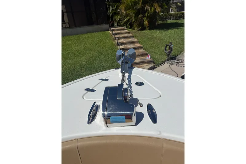 Slide: The Image of 2019 Cape Horn 27XS boat anchor system on deck, with lush greenery in the background. - 10