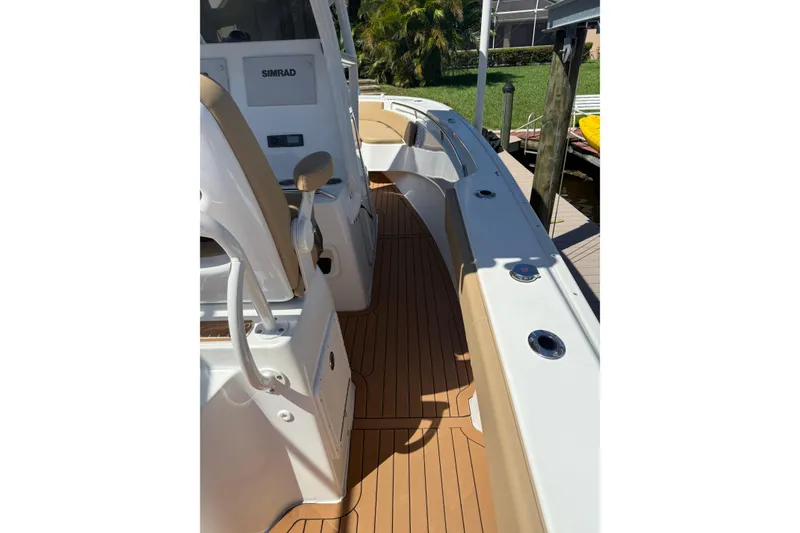 Slide: The Image of 2019 Cape Horn 27XS boat interior with teak flooring and Simrad electronics. - 11