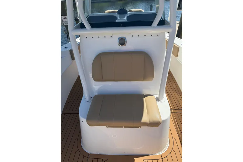 Slide: The Image of 2019 Cape Horn 27XS boat interior with tan seating and wood-style flooring. - 15