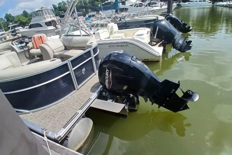 Slide: The Image of 2023 Cypress Cay Seabreeze 232 pontoon boat docked with Mercury outboard motor. - 13