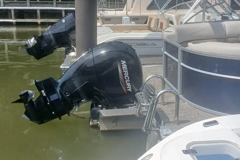 Slide: The Image of 2023 Cypress Cay Seabreeze 232 pontoon boat with Mercury outboard motor at dock. - 14
