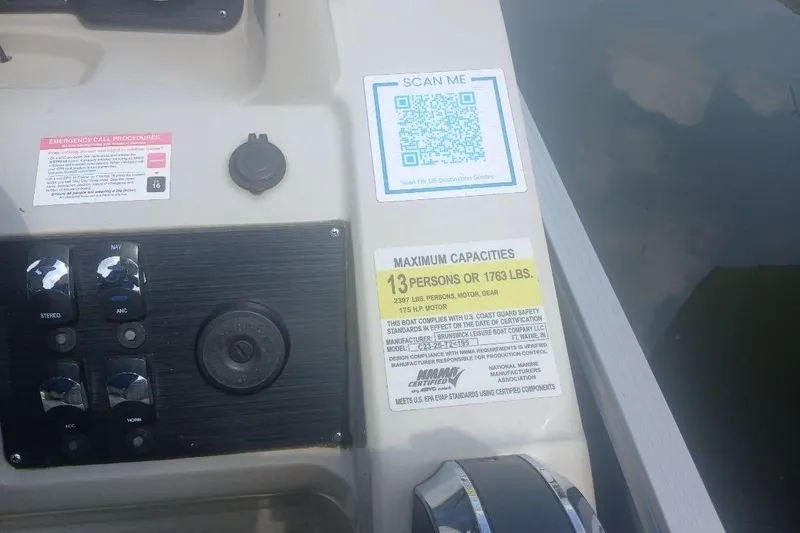 Slide: The Image of Control panel of 2023 Cypress Cay Seabreeze 232 with capacity and safety labels. - 15