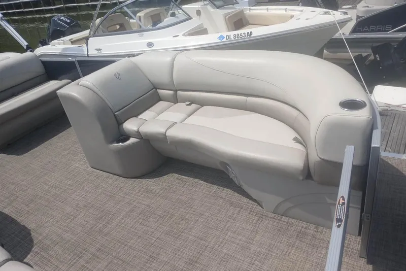 Slide: The Image of 2023 Cypress Cay Seabreeze 232 pontoon boat with beige seating and cup holders. - 9