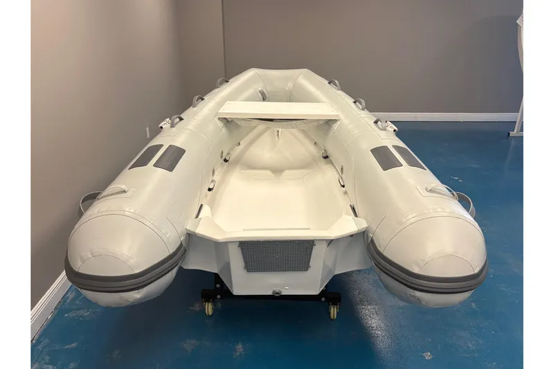 Slide: The Image of 2024 Caribe L-9 inflatable boat displayed indoors with decorative plants. - 5