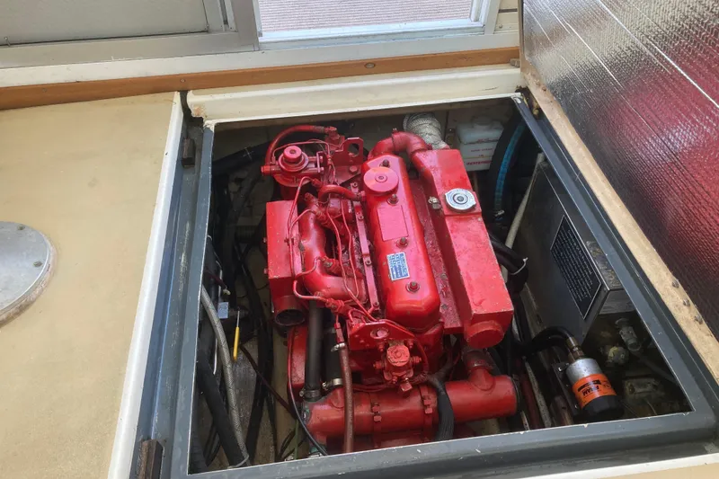 Slide: The Image of Engine compartment of a 1989 Cape Dory 300 Motorsailer with a red engine. - 11