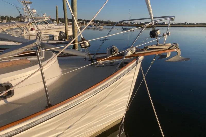 Slide: The Image of 1989 Cape Dory 300 Motorsailer docked in serene marina setting. - 4