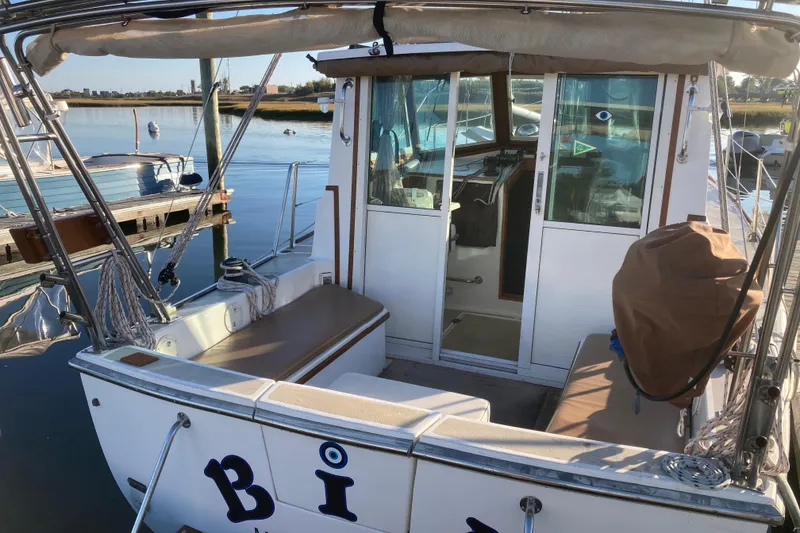 Slide: The Image of 1989 Cape Dory 300 Motorsailer docked, showcasing cockpit and cabin entrance. - 5
