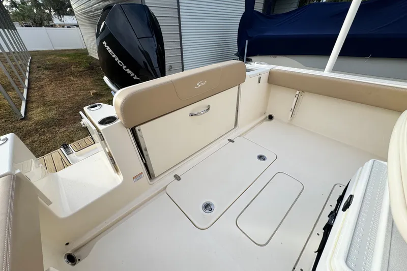Slide: The Image of 2023 Scout 240 XSF boat interior with Mercury engine, featuring spacious seating and storage. - 13