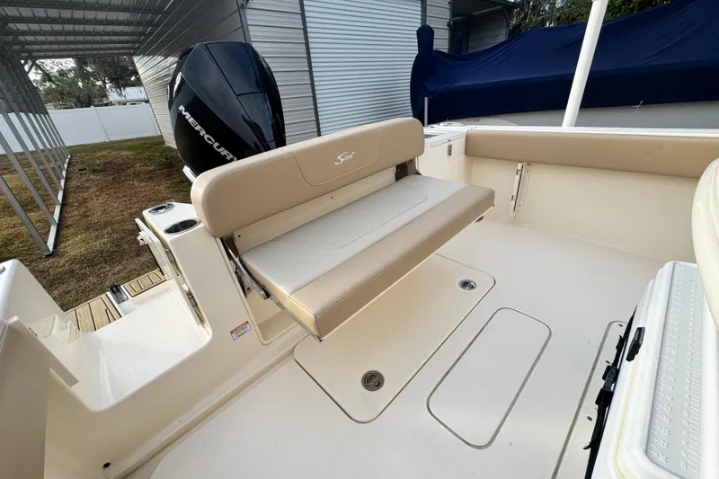 Slide: The Image of 2023 Scout 240 XSF boat interior with seating and Mercury engine. - 14