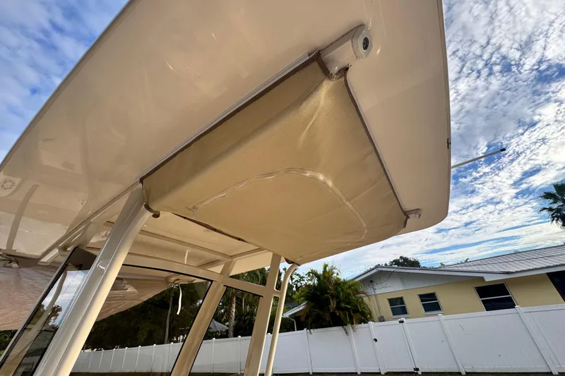 Slide: The Image of 2023 Scout 240 XSF boat canopy under a clear blue sky. - 17