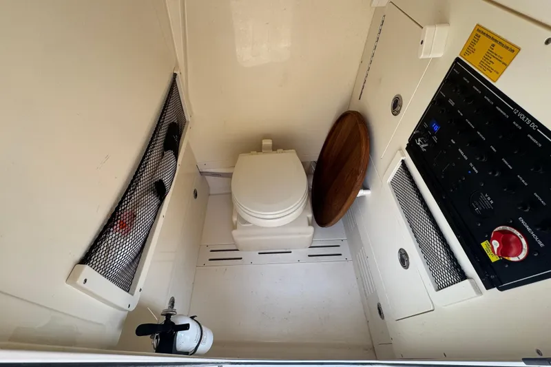 Slide: The Image of Interior of 2023 Scout 240 XSF with toilet and control panel. - 31
