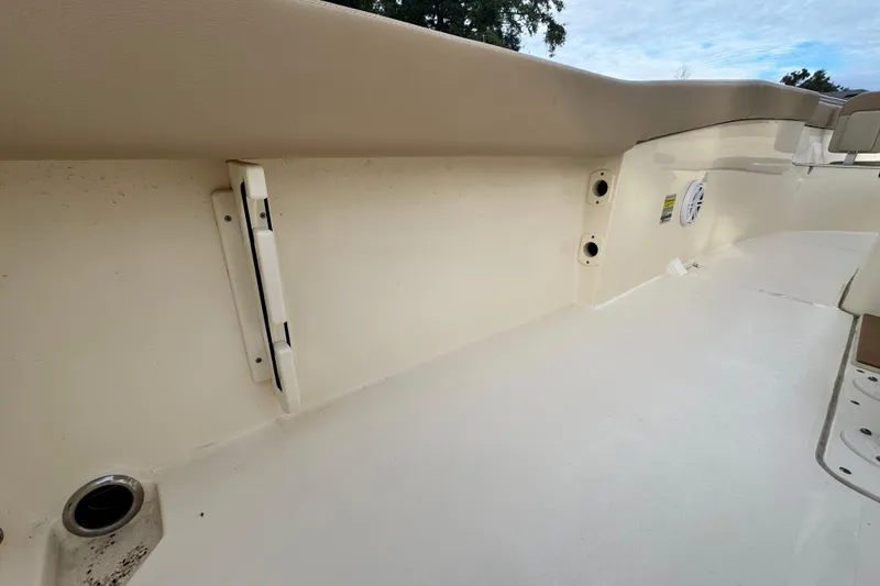 Slide: The Image of 2023 Scout 240 XSF boat interior, featuring clean white deck and side panel details. - 32