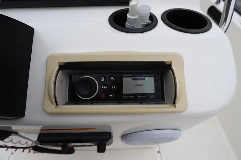 Slide: The Image of 2013 Boston Whaler 210 Montauk boat console with Fusion stereo system and cup holders. - 15