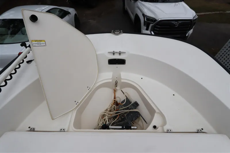 Slide: The Image of 2013 Boston Whaler 210 Montauk boat storage compartment with ropes and equipment. - 22