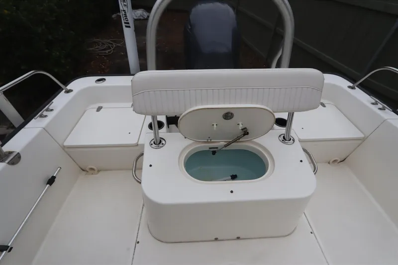 Slide: The Image of 2013 Boston Whaler 210 Montauk boat interior with open livewell and seating. - 25