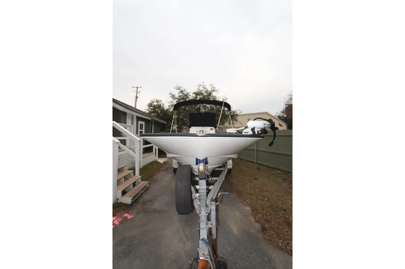 Slide: The Image of 2013 Boston Whaler 210 Montauk boat on trailer, parked outdoors. - 3