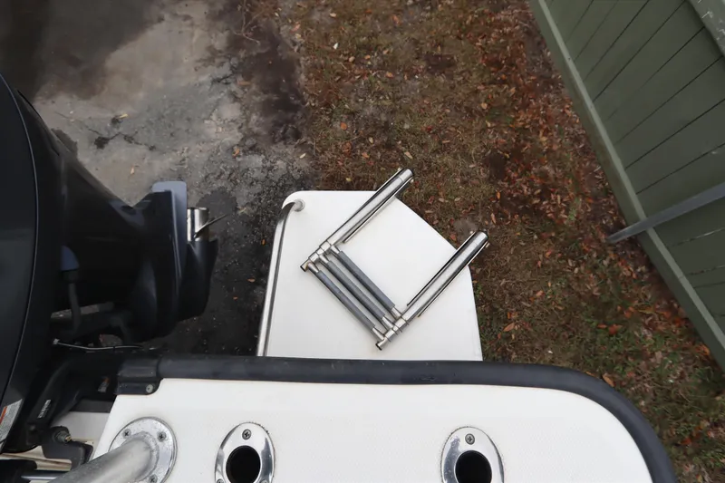 Slide: The Image of 2013 Boston Whaler 210 Montauk boat ladder and motor detail. - 33